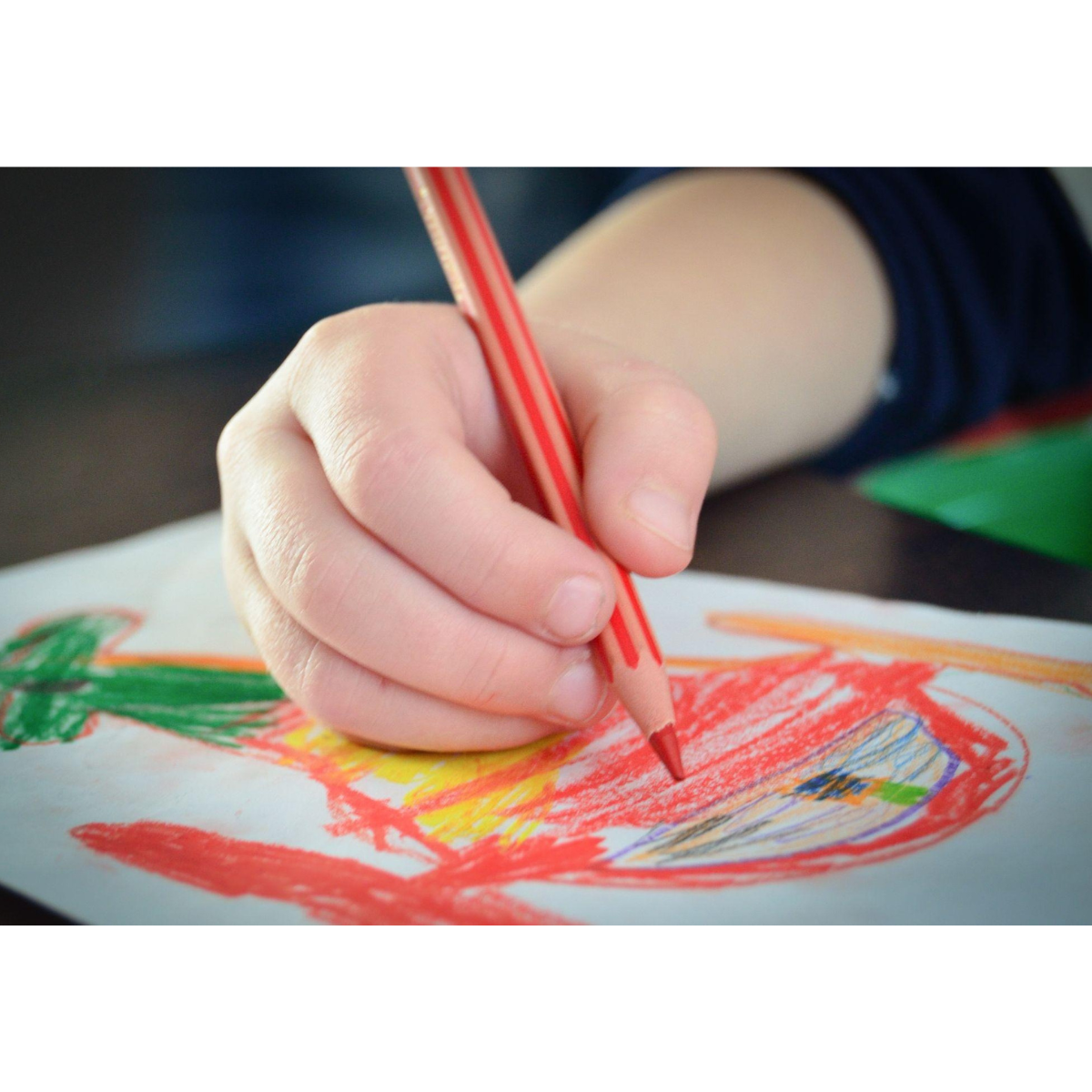 A child using colored pencils - a great affordable homeschooling resource