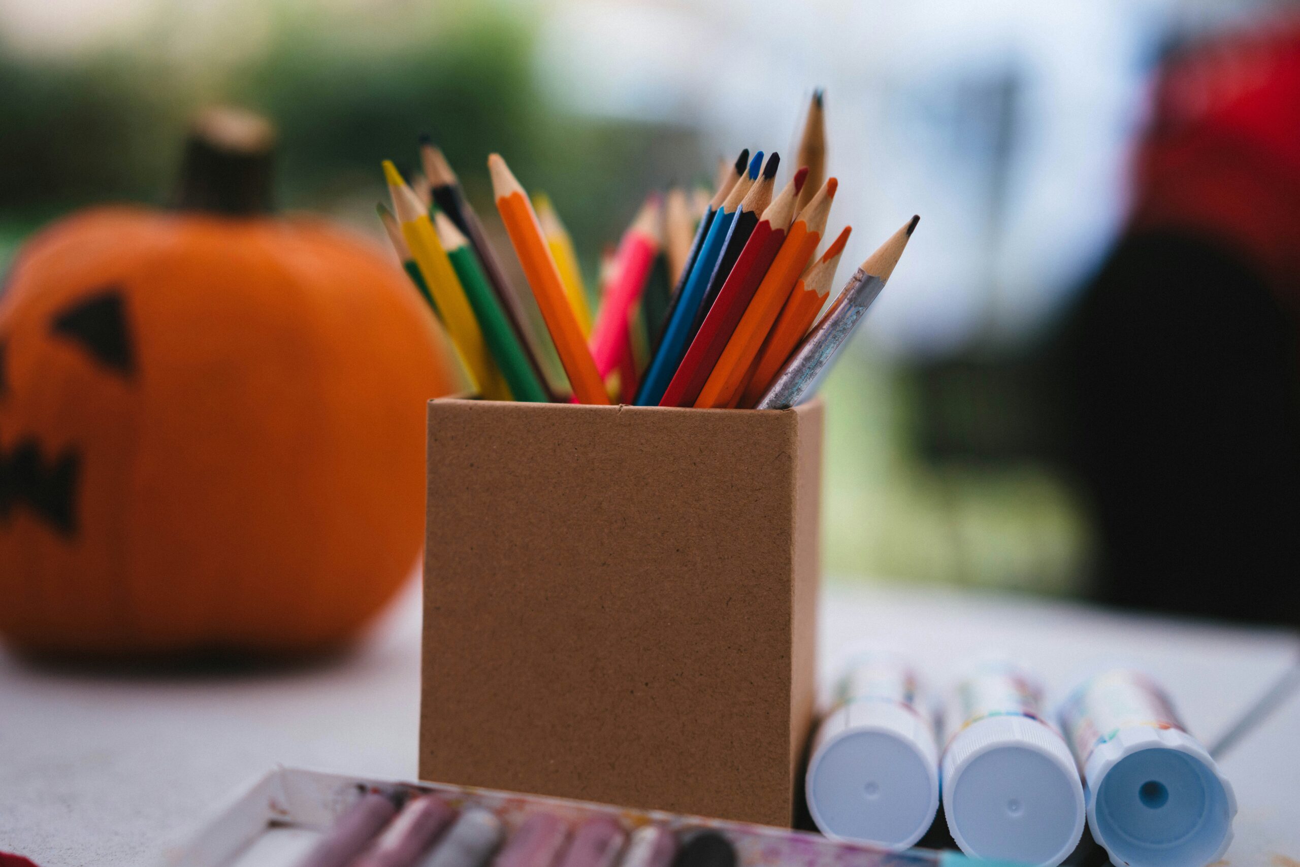 Colored pencils and a halloween pumpkin