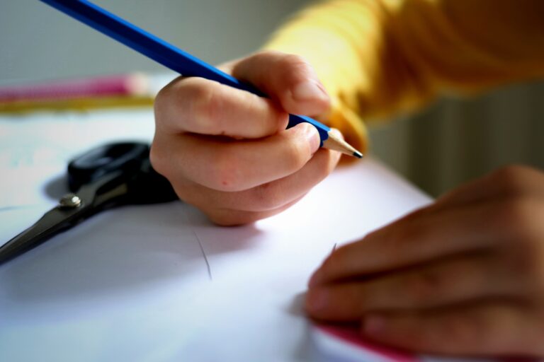 First grader writing on paper