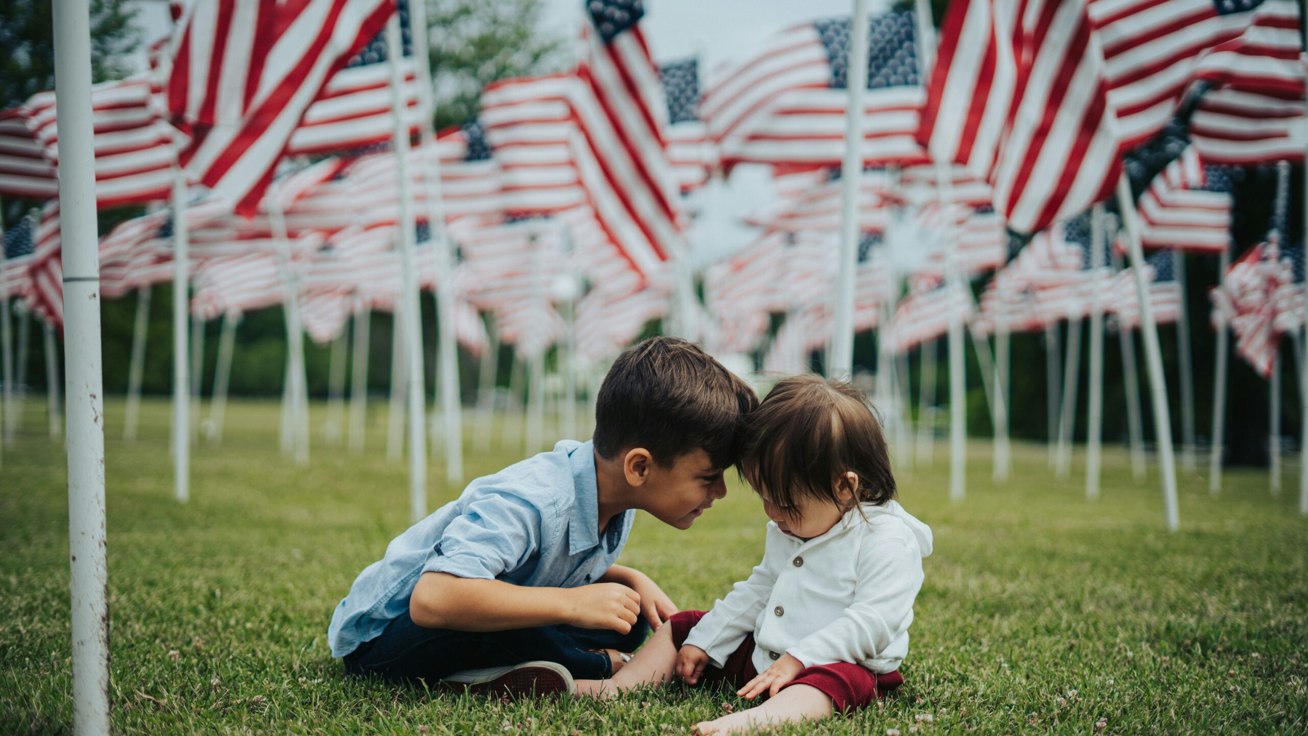 Children in a field of American Flags on Veterans Day