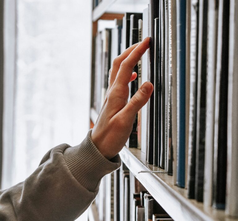 child touching books in the library