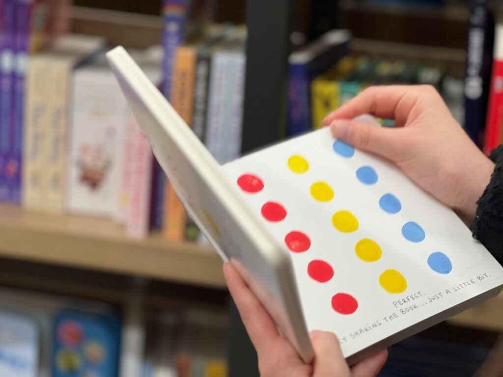 child reading a book in the library