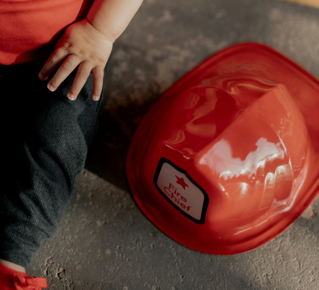 fire helmet next to child